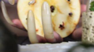 A GAINT WOMAN WITH LONG CLAWS AND TINY HUMAN